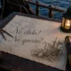 Antique nautical chart on a ship's deck table inscribed 'No clicks? No queries?' with a pen-and-ink giant squid attacking a pirate ship